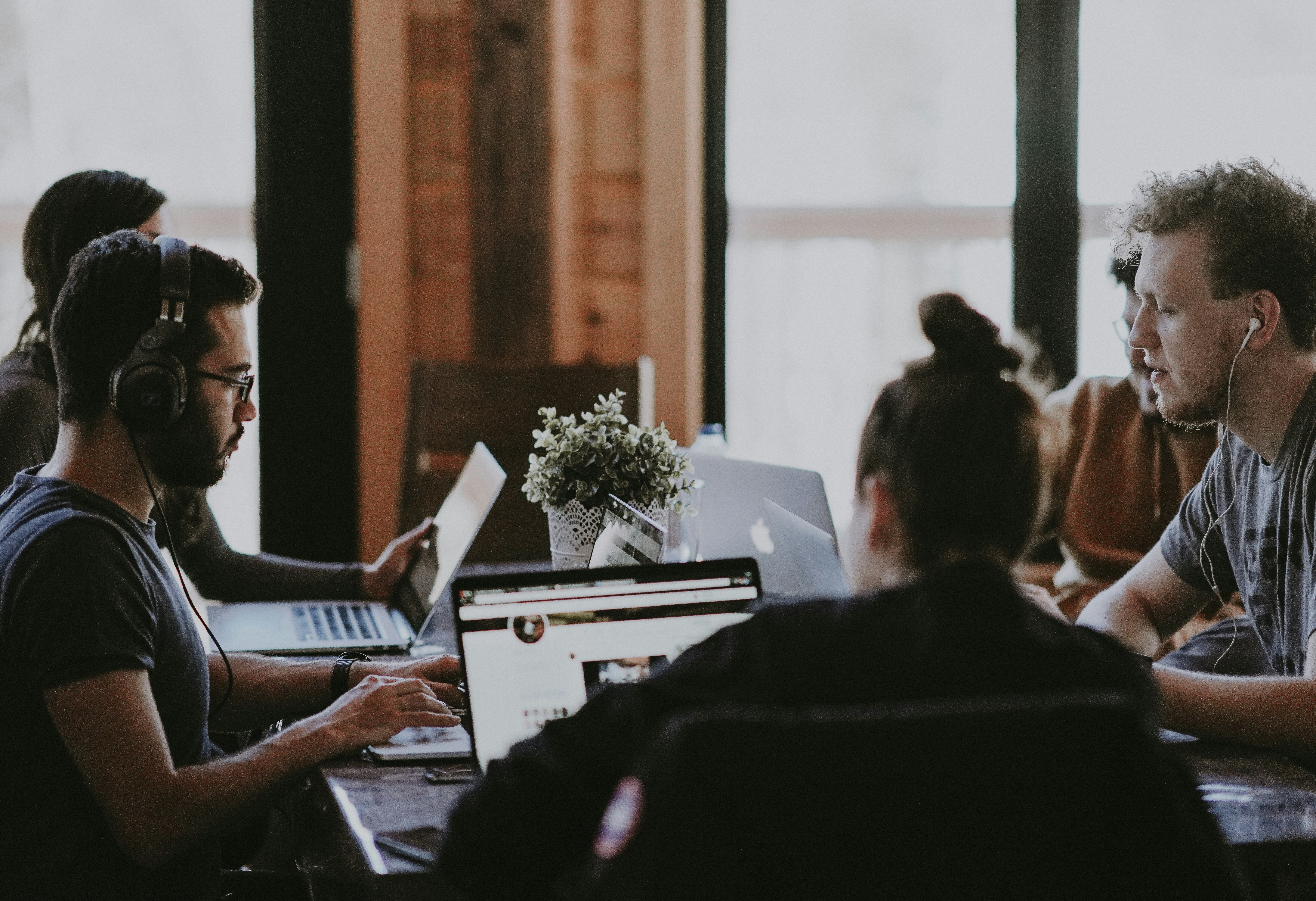 men women on laptop at desk 