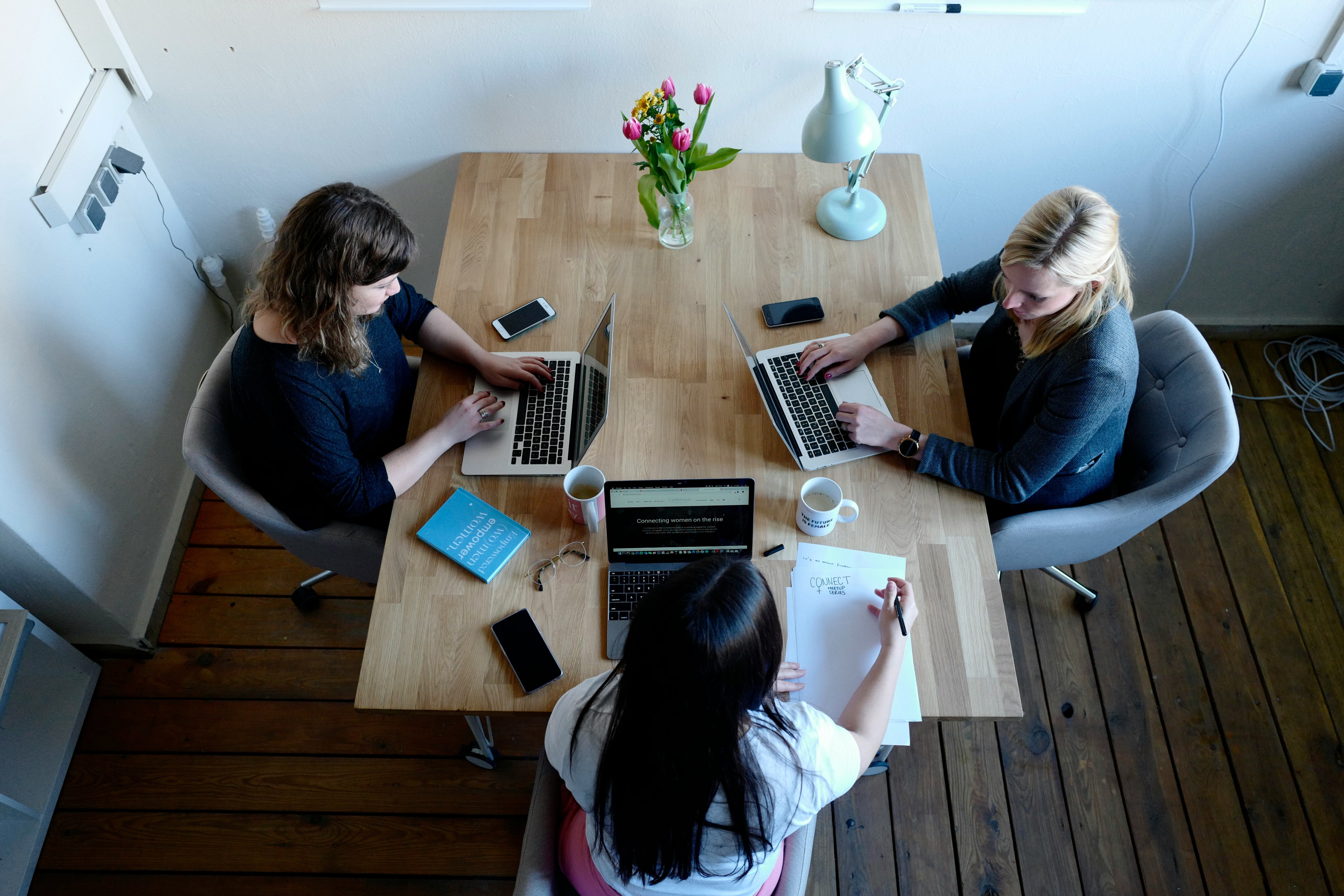 women with laptops at table 